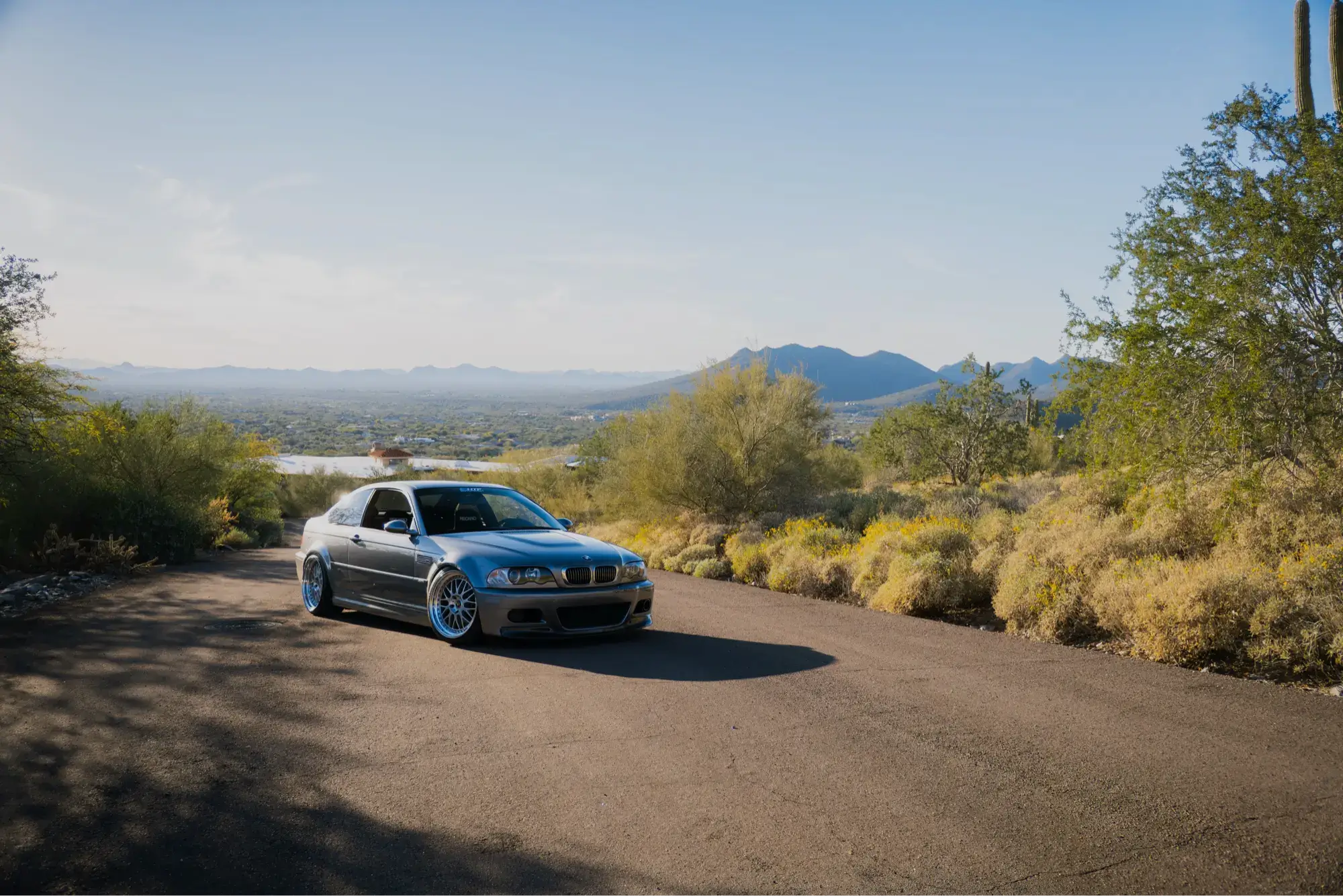 Grey BMW E46 M3 parked on a desert mountain overlook road above Tempe, Arizona, an HTP Motorsport project vehicle.