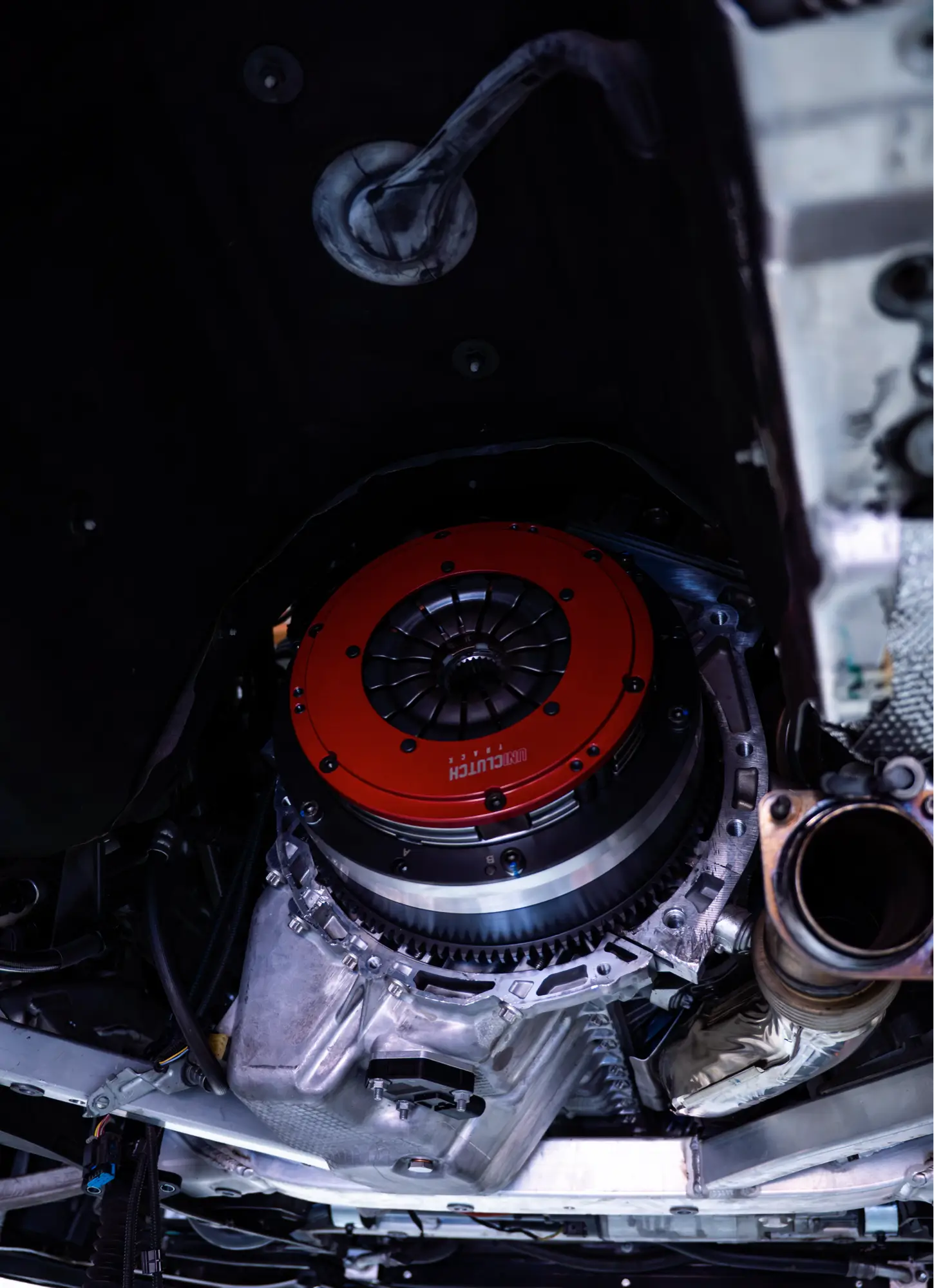 Close-up of a clutch installation on a vehicle's transmission at HTP Motorsport.